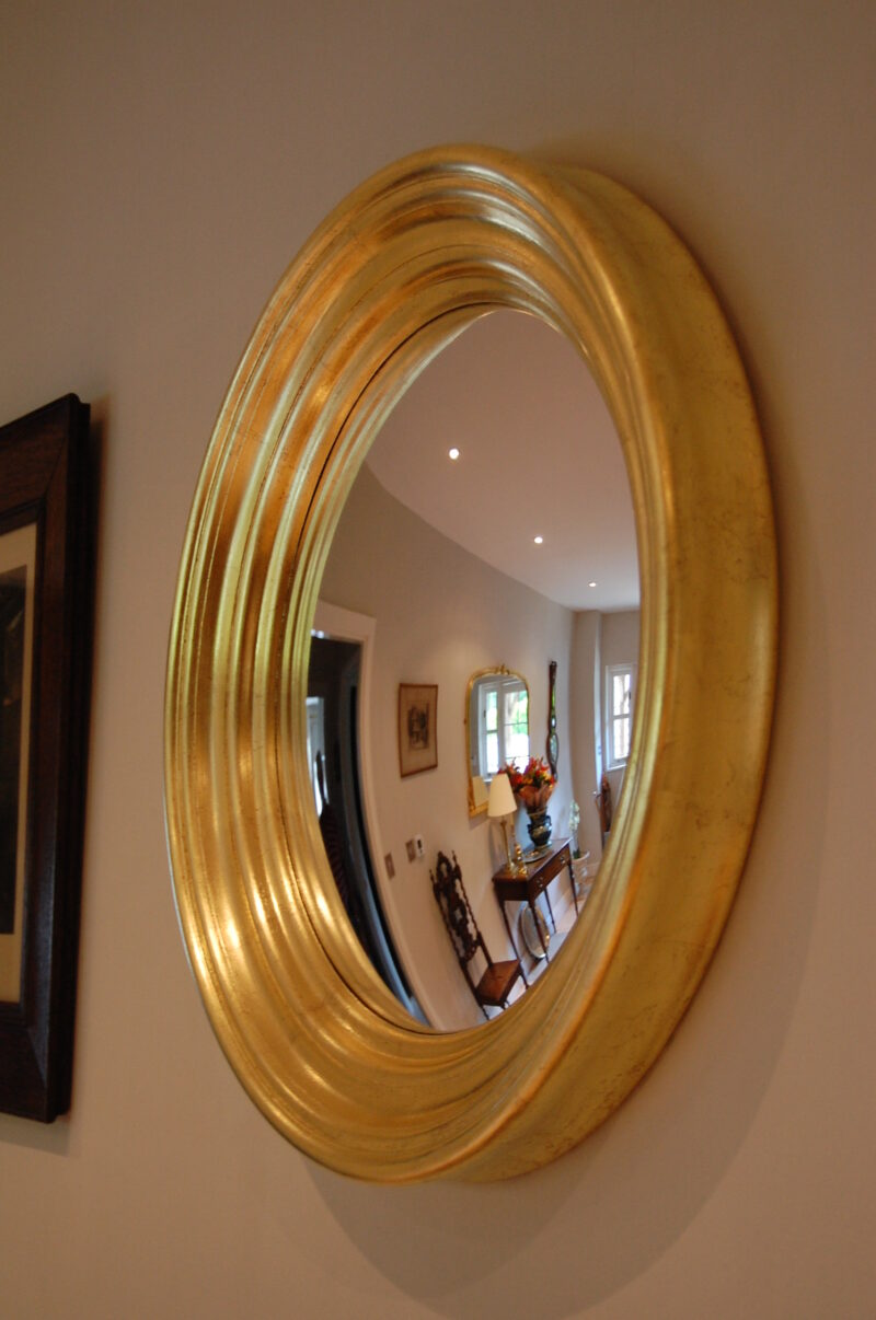 Detail of handcrafted convex mirror showing curved reflection